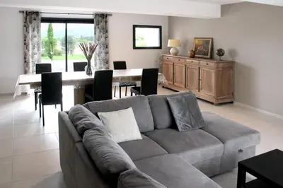 a living room with a couch and a table at Domaine des Marronniers in Tourtrol