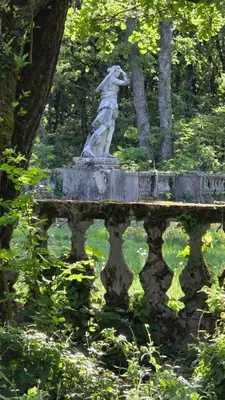a statue of a woman sitting on a bridge at Chateau de Pourpry in Damiatte