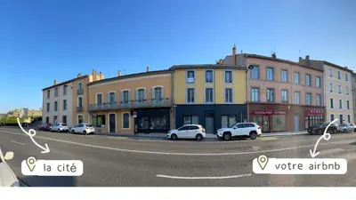 a city street with cars parked in front of buildings at Chez-YU in Carcassonne
