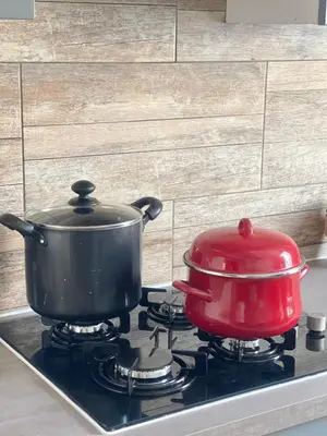 two pots and pans sitting on top of a stove at Chez-YU in Carcassonne