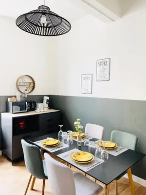 a dining room with a black table and chairs at Chez-YU in Carcassonne