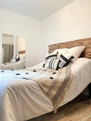 a bedroom with a large bed with pillows on it at Chez-YU in Carcassonne