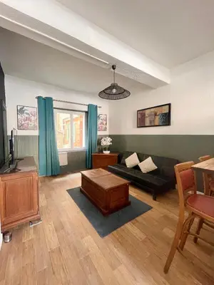 a living room with a couch and a table at Chez-YU in Carcassonne