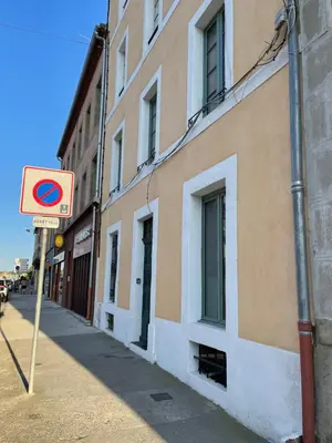a street sign on a sidewalk next to a building at Chez-YU in Carcassonne