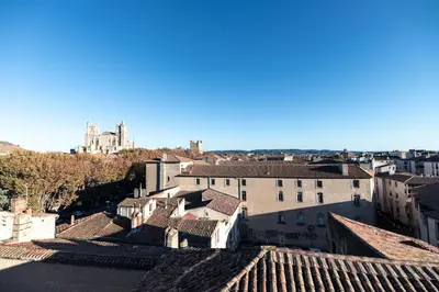a view of a city from the roofs of buildings at Chambre Orientale Chérazade Maison de L'Église in Narbonne