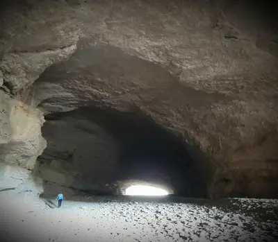 a person walking through a tunnel in a cave at Le Chalet in Saint-Jean-de-Minervois