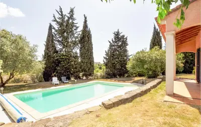 a swimming pool in the backyard of a house at Lovely Home In Limoux in Limoux