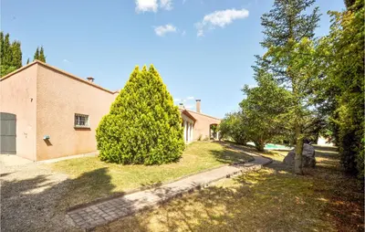 a house with a large tree in the yard at Lovely Home In Limoux in Limoux