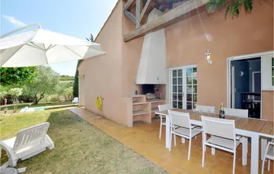 a patio with a table and chairs and an umbrella at Lovely Home In Limoux in Limoux
