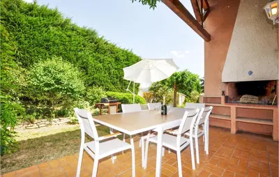 a table and chairs on a patio with an umbrella at Lovely Home In Limoux in Limoux