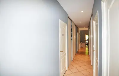 a hallway with white doors and a tile floor at Lovely Home In Limoux in Limoux