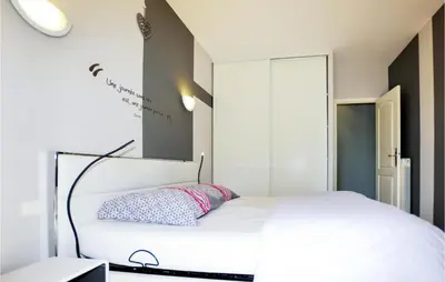 a bedroom with a white bed with a pillow on it at Lovely Home In Limoux in Limoux