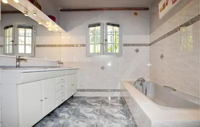 a white bathroom with a tub and a sink at Lovely Home In Limoux in Limoux