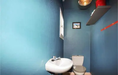 a blue bathroom with a sink and a toilet at Lovely Home In Limoux in Limoux