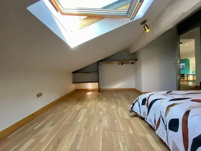 a attic bedroom with a bed and a skylight at L'Aigle d'or - Vue cité médiévale in Carcassonne