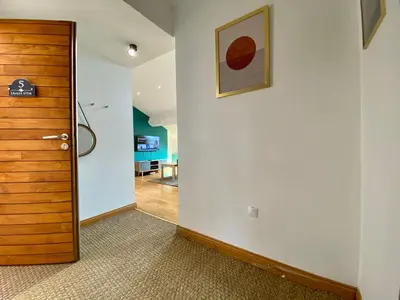 a hallway with a door and a painting on a wall at L'Aigle d'or - Vue cité médiévale in Carcassonne