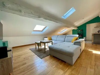 a living room with a couch and a table at L'Aigle d'or - Vue cité médiévale in Carcassonne