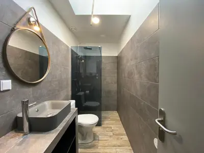 a bathroom with a sink and a toilet and a mirror at L'Aigle d'or - Vue cité médiévale in Carcassonne