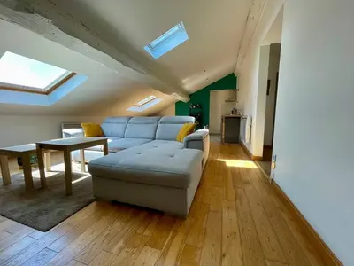 a living room with a couch and a table at L'Aigle d'or - Vue cité médiévale in Carcassonne