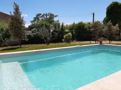 a large blue swimming pool in a yard at Elegant Villa in Sainte Valière in Sainte-Vallière