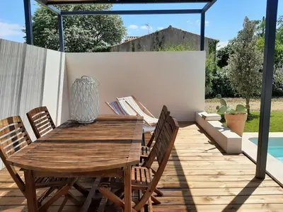 a wooden table and chairs on a wooden deck at Elegant Villa in Sainte Valière in Sainte-Vallière