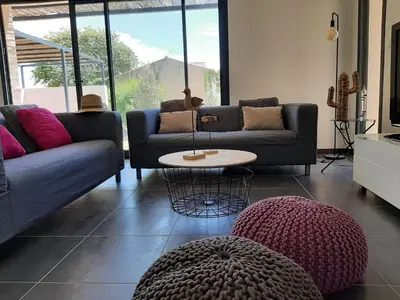 a living room with two couches and a table at Elegant Villa in Sainte Valière in Sainte-Vallière