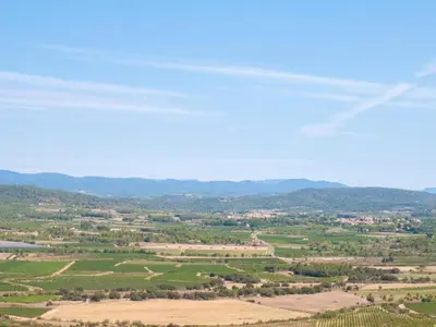an aerial view of a cultivated field with mountains in the background at Elegant Villa in Sainte Valière in Sainte-Vallière
