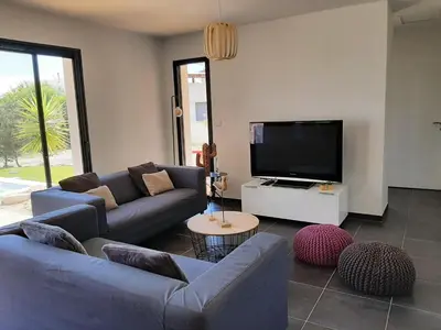 a living room with couches and a flat screen tv at Elegant Villa in Sainte Valière in Sainte-Vallière
