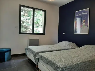 a bedroom with two beds and a window at Elegant Villa in Sainte Valière in Sainte-Vallière