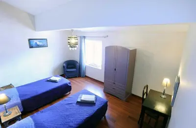 a room with two beds and a table and a chair at Cecile in Montgaillard