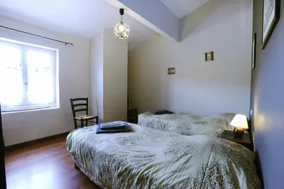 a bedroom with two beds and a window at Cecile in Montgaillard