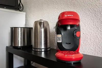 a red mixer sitting on a black table at Le Cocon / Free Parking / Wifi / Netflix in Carcassonne