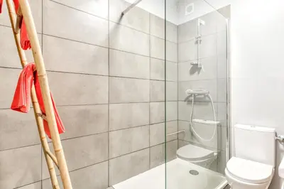 a bathroom with a toilet and a glass shower at Le Cocon / Free Parking / Wifi / Netflix in Carcassonne