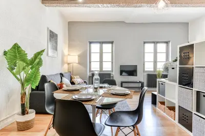 a dining room and living room with a table and chairs at Le Cocon / Free Parking / Wifi / Netflix in Carcassonne