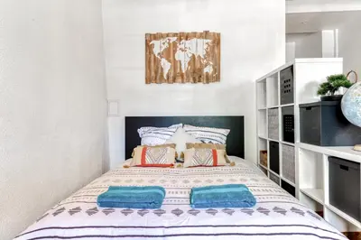 a bedroom with a large bed with blue pillows at Le Cocon / Free Parking / Wifi / Netflix in Carcassonne
