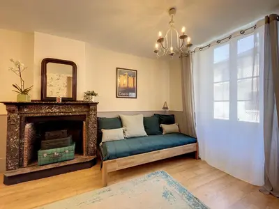 a living room with a couch and a fireplace at L'oiseau Bleu FLAMANT in Roubia