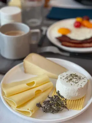 a plate of cheese and other foods on a table at L'oiseau Bleu FLAMANT in Roubia