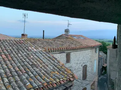 an old building with tile roofs with a view at La Maison de Leontine in La Livinière