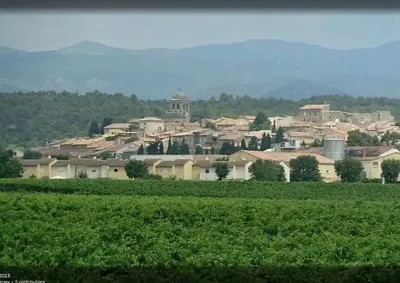 a town in the middle of a field next to a farm at La Maison de Leontine in La Livinière