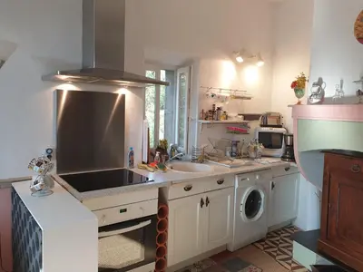 a kitchen with a sink and a stove top oven at La Pinède in Azillanet