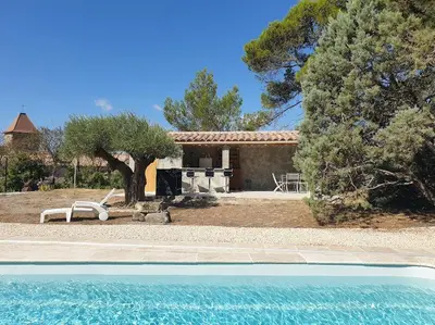 a house with a swimming pool in front of a house at La Pinède in Azillanet