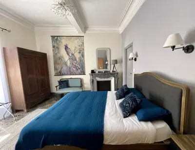 a bedroom with a blue bed with a blue blanket at L'Oiseau Bleu PEACOCK in Roubia