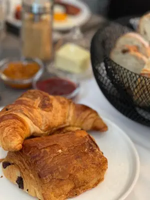 a plate with croissants and other pastries on a table at L'Oiseau Bleu PEACOCK in Roubia