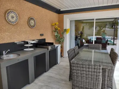 a kitchen with a table and a dining room at Petit Rêve des Corbières in Durban-Corbières