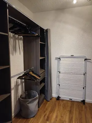 a room with a closet with a door and shelves at Escale à Gruissan au coeur de la Marina in Gruissan