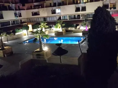 a large courtyard with a pool in a building at Escale à Gruissan au coeur de la Marina in Gruissan