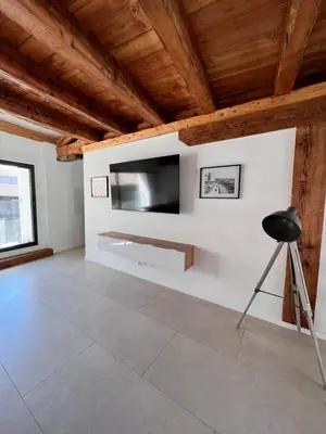 a living room with a flat screen tv on a wall at Beau T3 au cœur du centre ville in Narbonne
