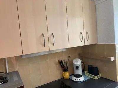 a kitchen counter with white cabinets and a blender at Gruissan les MARINES II in Gruissan