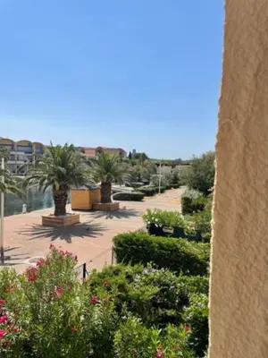 a view of a garden with plants and trees at Gruissan les MARINES II in Gruissan