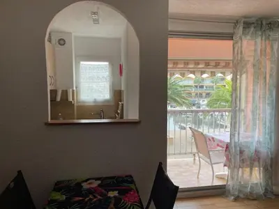 a living room with an open door to a patio at Gruissan les MARINES II in Gruissan